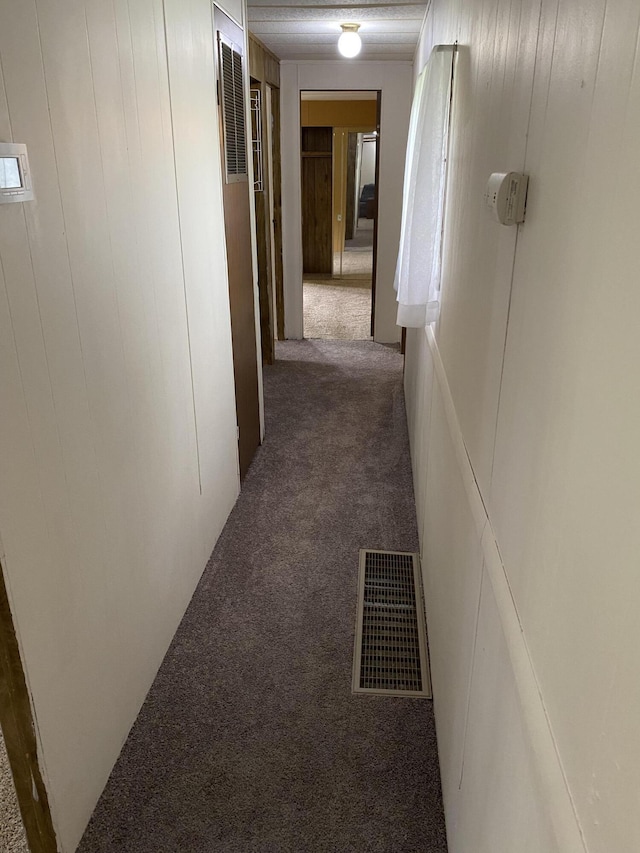 hallway with carpet and visible vents