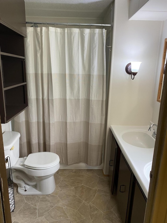 full bathroom featuring a sink, toilet, double vanity, and a shower with shower curtain