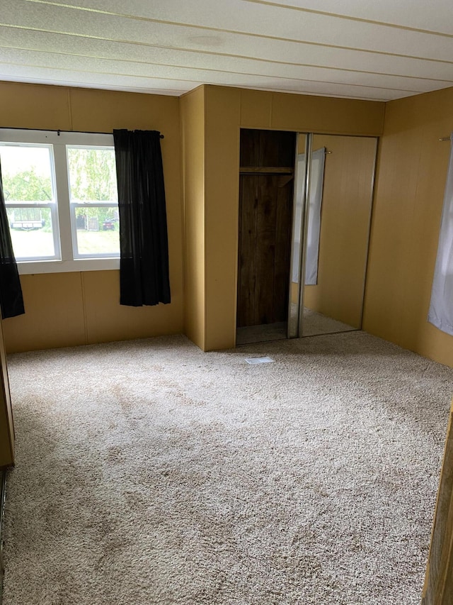unfurnished bedroom featuring carpet and a closet