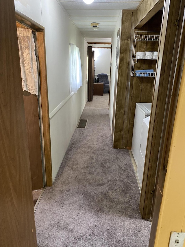 hallway featuring visible vents and carpet flooring