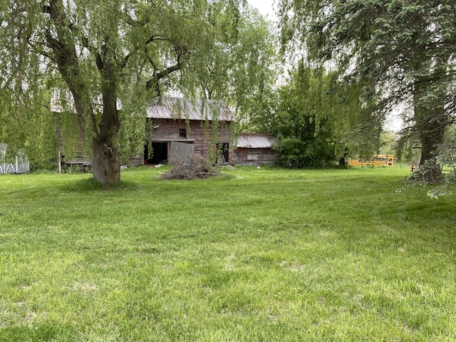 view of yard with a barn and an outbuilding
