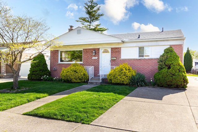 bungalow-style house featuring brick siding, a chimney, and a front yard