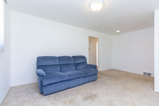 living area with carpet flooring and visible vents