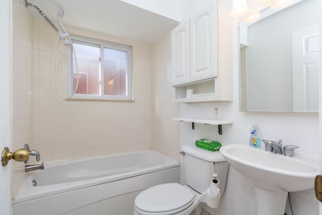 bathroom with a sink, toilet, and shower / washtub combination