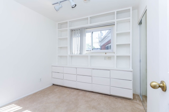 unfurnished bedroom featuring light colored carpet