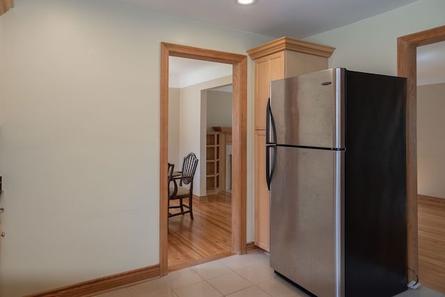 kitchen featuring freestanding refrigerator, light brown cabinetry, baseboards, recessed lighting, and light tile patterned floors