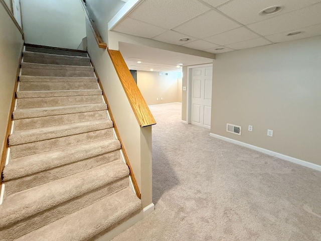 staircase featuring carpet flooring, baseboards, a paneled ceiling, and recessed lighting