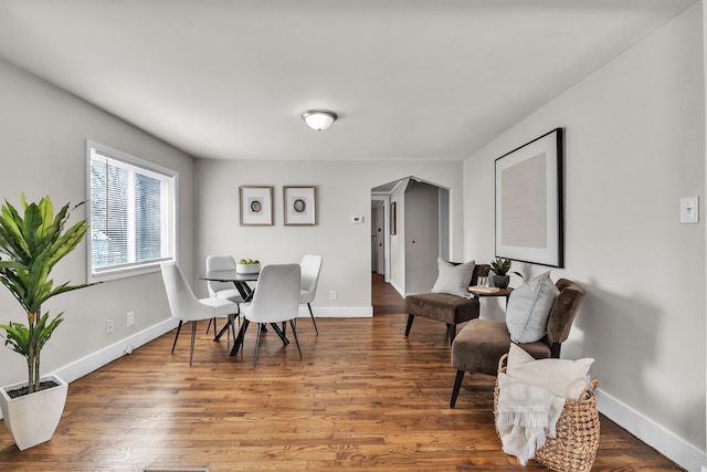 2040 Freeman St, Westland, MI 48186 - dining space with baseboards, arched walkways, and wood finished floors
