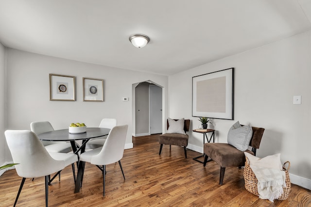 2040 Freeman St, Westland, MI 48186 - dining room with arched walkways, baseboards, and wood finished floors