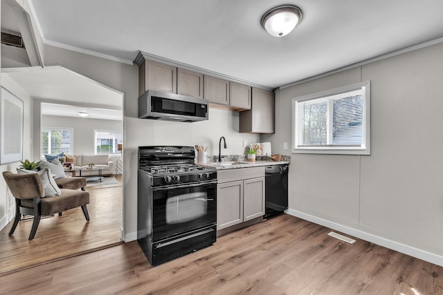2040 Freeman St, Westland, MI 48186 - kitchen featuring gray cabinets, visible vents, crown molding, a sink, and black appliances