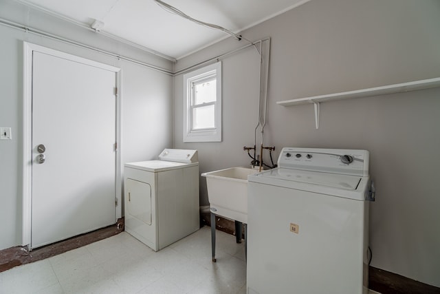 2040 Freeman St, Westland, MI 48186 - clothes washing area with laundry area, washer and clothes dryer, light floors, and a sink