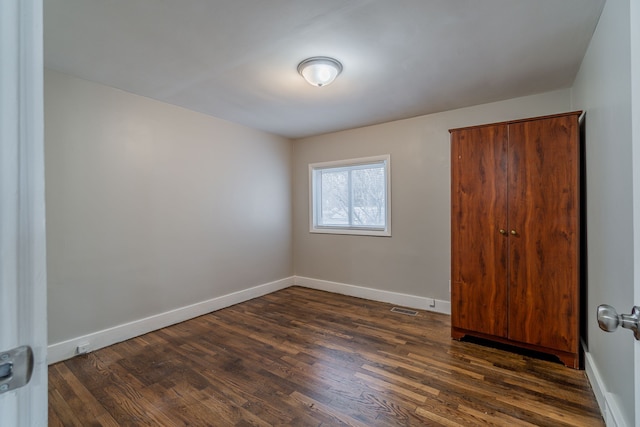 2040 Freeman St, Westland, MI 48186 - empty room featuring baseboards, dark wood-style flooring, and visible vents