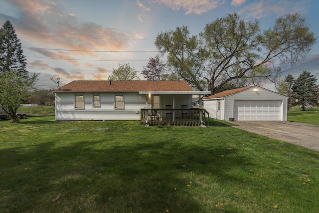 single story home with a garage, an outbuilding, and a front lawn