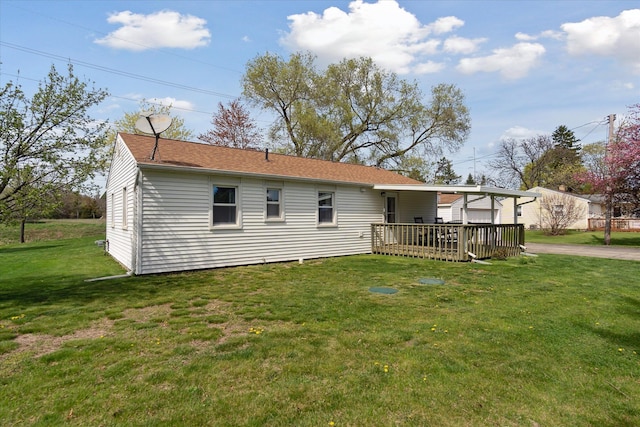 back of property with a lawn and a wooden deck