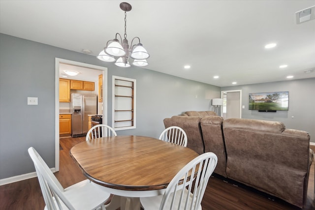 dining area with baseboards, a notable chandelier, dark wood-style floors, and visible vents