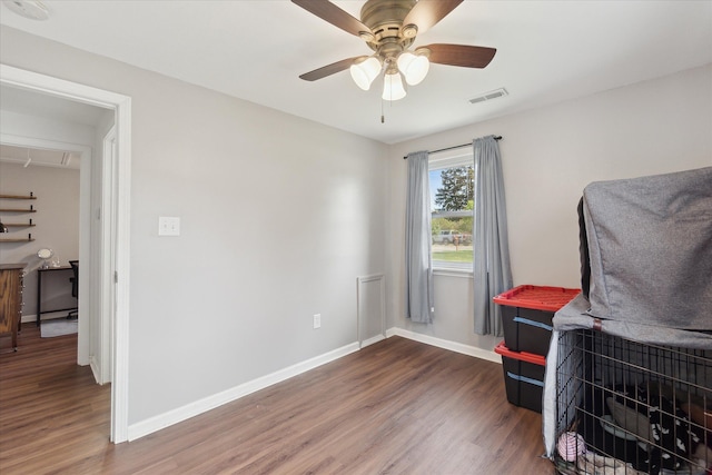 office with baseboards, ceiling fan, visible vents, and wood finished floors
