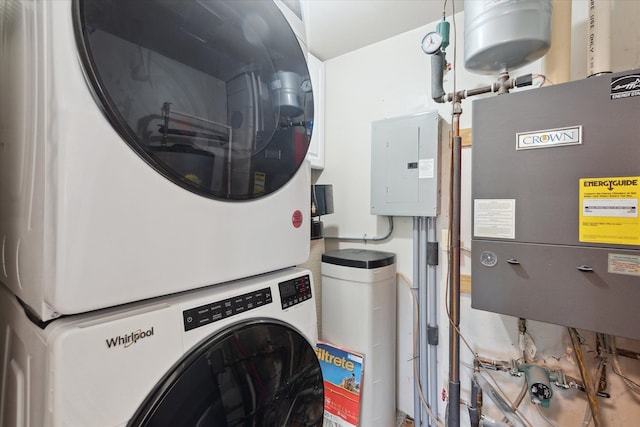 clothes washing area featuring laundry area, stacked washer / dryer, and electric panel