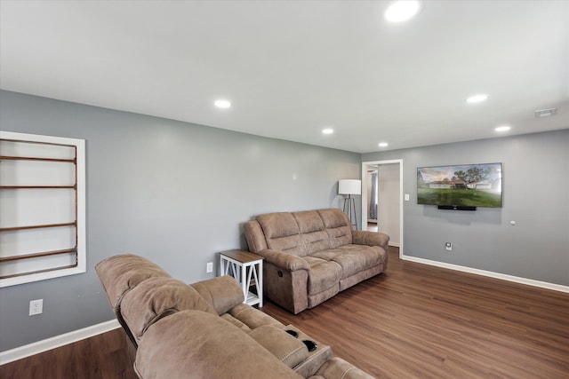living area with recessed lighting, baseboards, wood finished floors, and visible vents