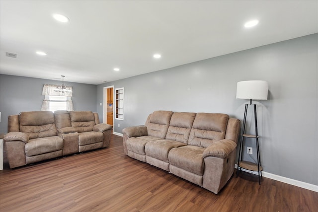 living room with baseboards, recessed lighting, wood finished floors, and a chandelier