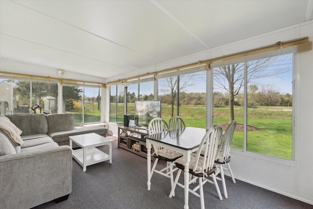 sunroom featuring plenty of natural light, carpet, and an outdoor living space