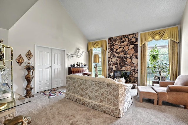 carpeted living room featuring high vaulted ceiling, a textured ceiling, and a stone fireplace