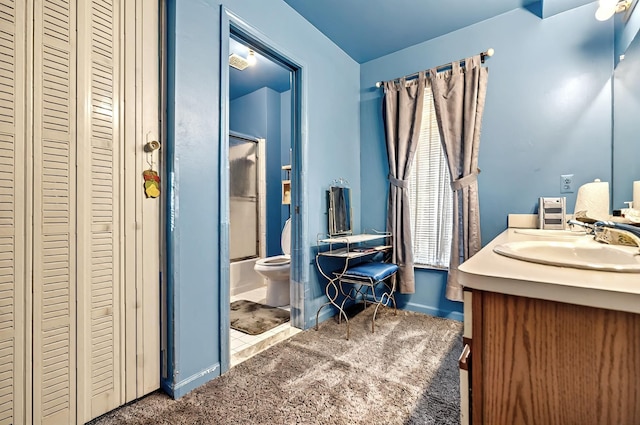full bath featuring vanity, baseboards, enclosed tub / shower combo, and toilet