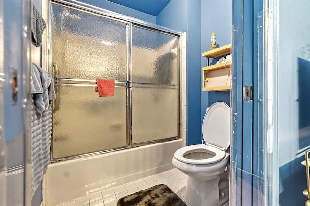 full bath featuring enclosed tub / shower combo, tile patterned floors, and toilet