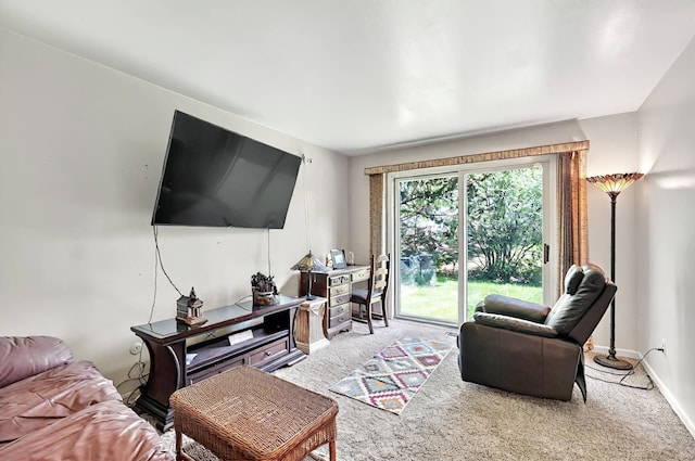 carpeted living room with baseboards