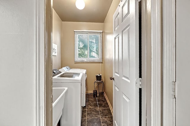 washroom featuring baseboards, laundry area, marble finish floor, and washing machine and clothes dryer