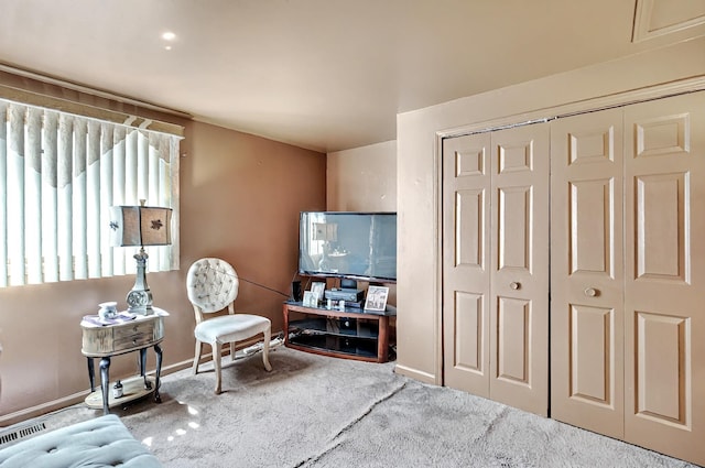 living area featuring carpet floors and baseboards