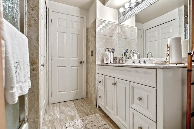 bathroom featuring tile walls and vanity