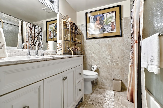 bathroom featuring a shower with curtain, visible vents, tile walls, vanity, and toilet