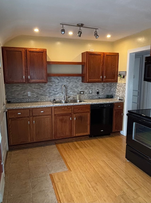 kitchen with open shelves, light stone counters, a sink, tasteful backsplash, and black appliances