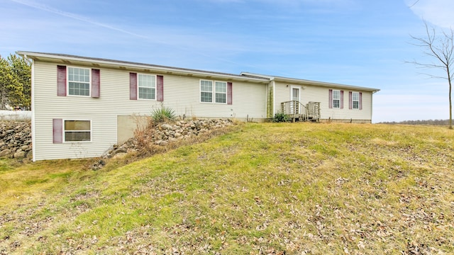 single story home featuring a front lawn