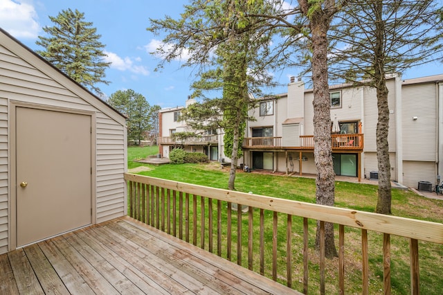 wooden deck with a lawn and central AC