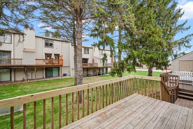 deck with a residential view and a yard