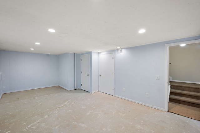 finished basement featuring stairs, recessed lighting, baseboards, and visible vents