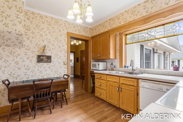 201 N Woodworth St, Corunna, MI 48817 - kitchen with white appliances, a chandelier, wallpapered walls, light wood finished floors, and light countertops