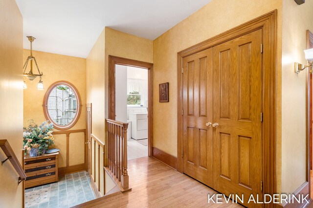 201 N Woodworth St, Corunna, MI 48817 - foyer entrance featuring washer / dryer, healthy amount of natural light, and light wood-style flooring