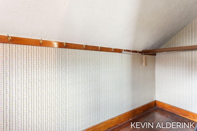 201 N Woodworth St, Corunna, MI 48817 - spacious closet with dark wood-style flooring and lofted ceiling