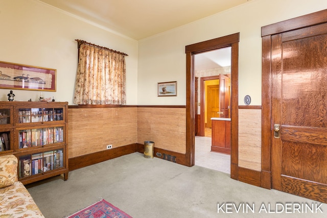 201 N Woodworth St, Corunna, MI 48817 - sitting room with carpet flooring, a wainscoted wall, and crown molding