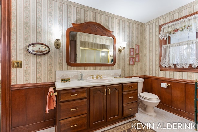 201 N Woodworth St, Corunna, MI 48817 - bathroom featuring vanity, tile patterned flooring, and a wainscoted wall