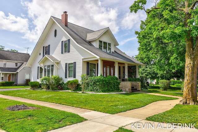 201 N Woodworth St, Corunna, MI 48817 - view of front of house with covered porch, a front lawn, and a chimney