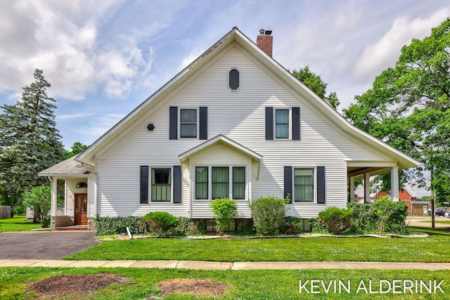 201 N Woodworth St, Corunna, MI 48817 - view of front facade featuring a chimney and a front lawn
