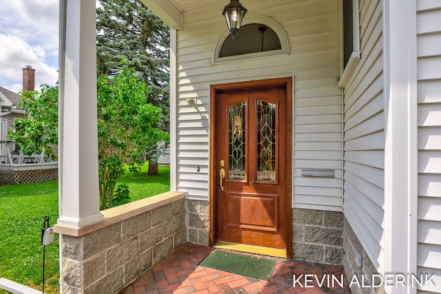 201 N Woodworth St, Corunna, MI 48817 - view of exterior entry with covered porch and a lawn