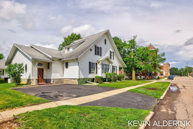 201 N Woodworth St, Corunna, MI 48817 - view of front facade featuring a shingled roof, driveway, and a front lawn