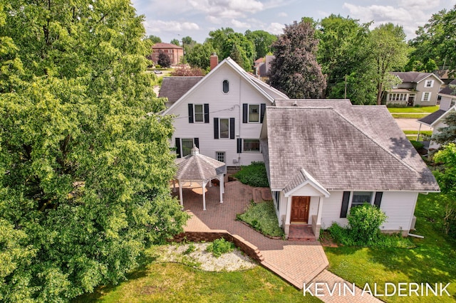 201 N Woodworth St, Corunna, MI 48817 - view of front facade featuring a gazebo, a shingled roof, view of scattered trees, and a front yard