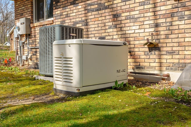 exterior details with a power unit, brick siding, and cooling unit