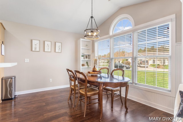dining room with an inviting chandelier, baseboards, lofted ceiling, and dark wood-type flooring