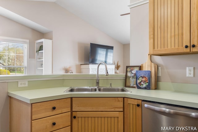 kitchen with a sink, light countertops, vaulted ceiling, and dishwasher